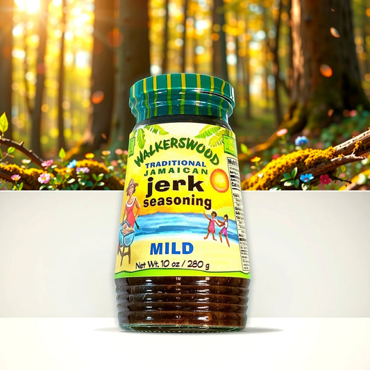 A jar of Walkerswood Jerk Seasoning (Mild) from TOJ EXPRESS is displayed. The label showcases colorful illustrations of a sun and people, set against a blurred forest background with sunlight filtering through the trees, enhancing its authentic Jamaican seasoning vibe.