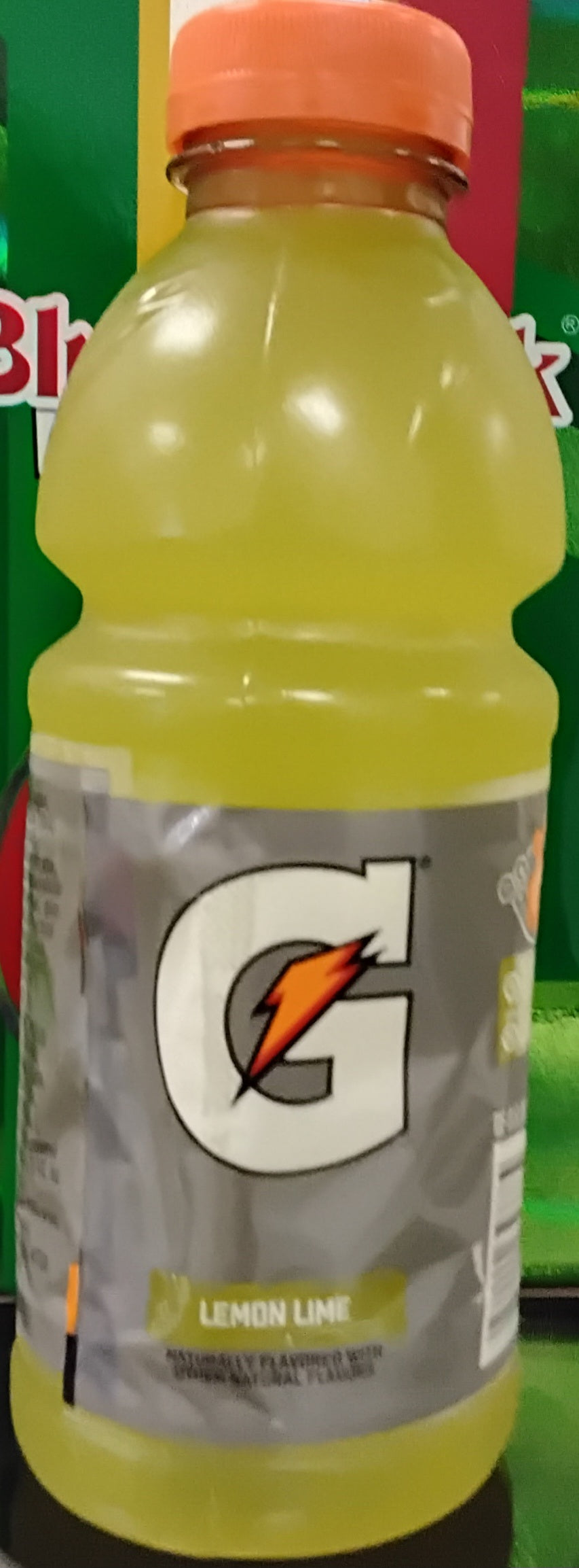 A 20 oz bottle of TOJ EXPRESS Gatorade Lemon Lime Drink features a yellow liquid, an orange cap, and a prominent G logo on the front.