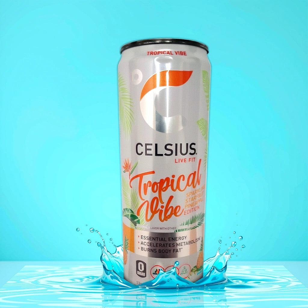 A can of TOJ EXPRESS Celsius Tropical Vibe Energy Drink stands on a reflective surface amidst a dynamic water splash. The slim, white can with vibrant orange and green accents displays the brand logo and energy blend claims that may aid in burning body fat, set against a bright blue background.
