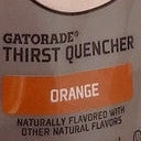 A close-up of a TOJ EXPRESS Gatorade Orange Drink (12 oz) label showcases the flavor in white font on an orange background. This naturally flavored sports drink helps replenish electrolytes during activity.