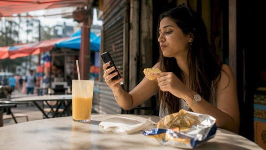Woman tasting American snack in Mumbai café
