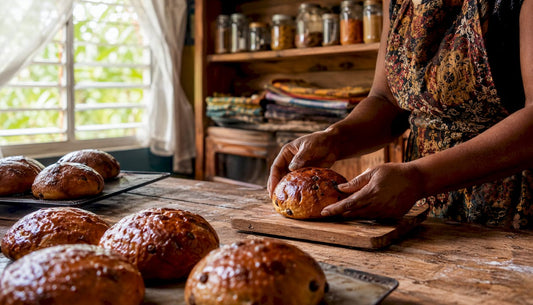 Freshly baked Caribbean spice buns on wooden bakery counter