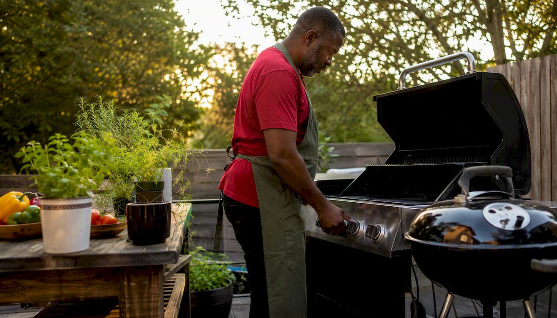 Man setting up propane gas and charcoal grills outdoors