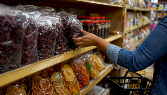 Caribbean specialty grocery shelf with dried hibiscus and spices