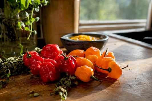 Scotch bonnet and habanero peppers on rustic table