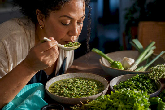 Cook tasting fresh green seasoning