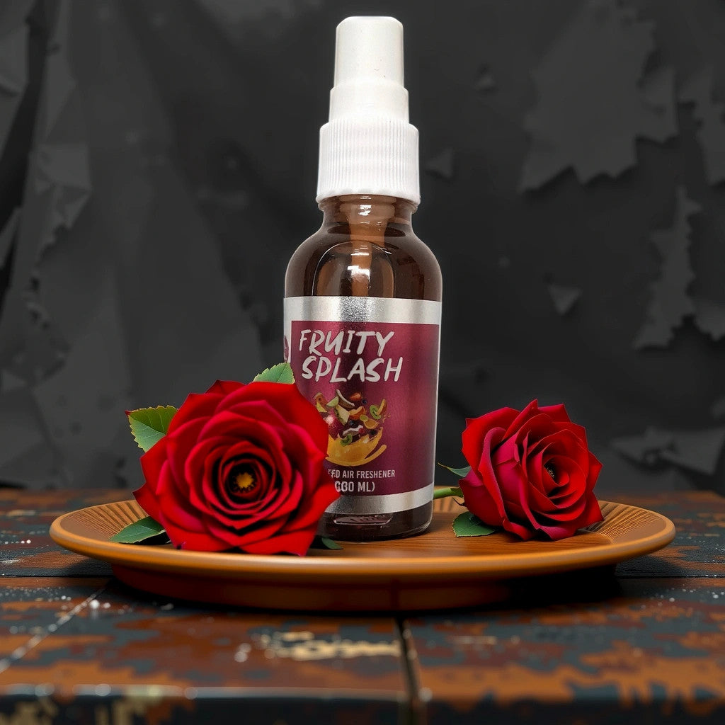 A brown spray bottle labeled Fruity Splash sits on a plate with two red roses, against a dark, textured background.