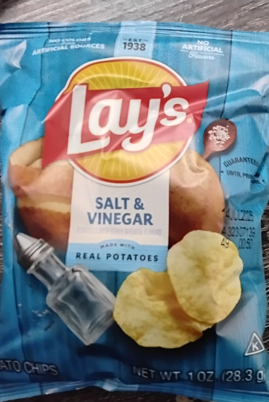 A blue 1 oz bag of TOJ EXPRESS Lays Salt & Vinegar Chips features savory snacks with potato chips, a salt shaker, and whole potatoes. The pack highlights “Made with Real Potatoes” and has a net weight of 28.3g.