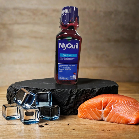 A bottle of TOJ EXPRESS NyQuil rests on a dark stone slab among ice cubes and a raw salmon fillet, all set atop a wooden surface with a neutral background.