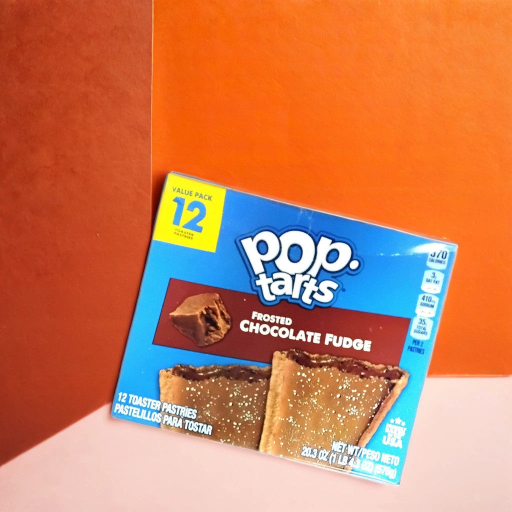 A box of TOJ EXPRESS Pop Tarts-Frosted Chocolate Fudge sits on a two-tone orange background, showing the chocolaty pastries on the packaging and noting that it contains 12 toaster pastries.