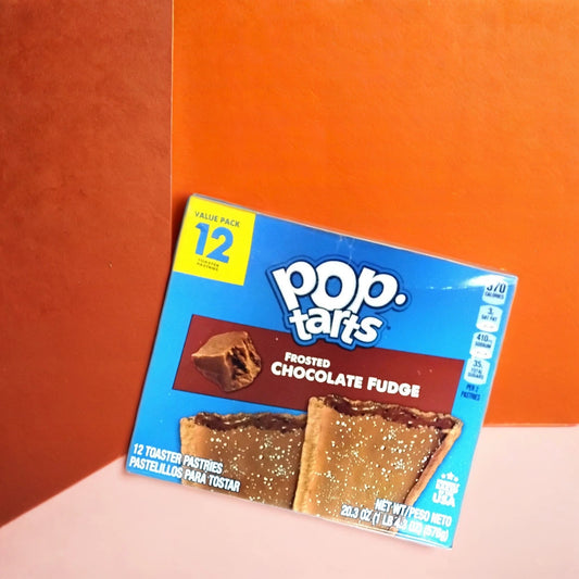 A box of TOJ EXPRESS Pop Tarts-Frosted Chocolate Fudge sits on a two-tone orange background, showing the chocolaty pastries on the packaging and noting that it contains 12 toaster pastries.