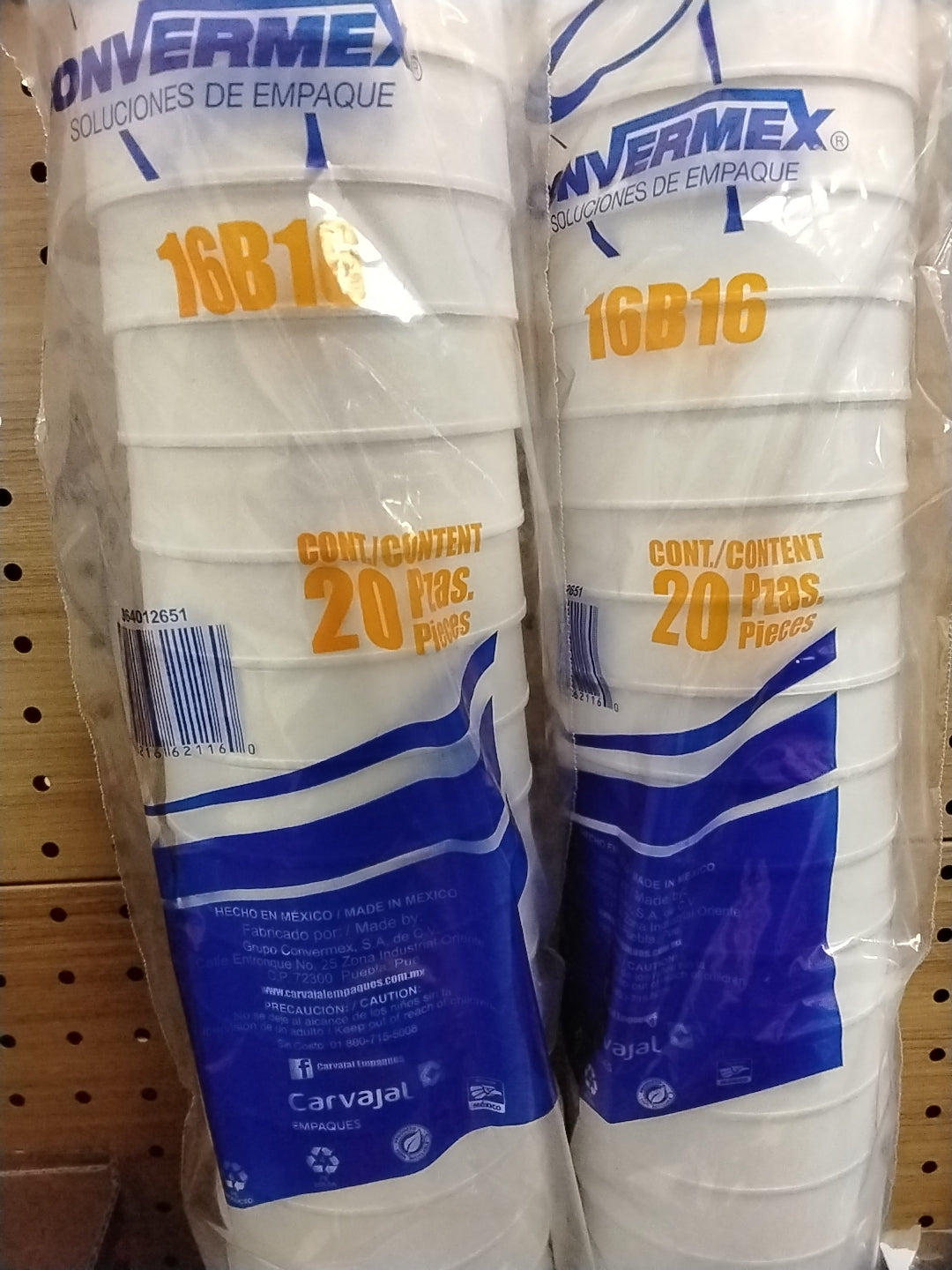 Two packages of TOJ EXPRESS Vaso Termico Foam Cups (16 oz, 20 count each) are displayed upright on a pegboard shelf. The packaging features blue and orange text.